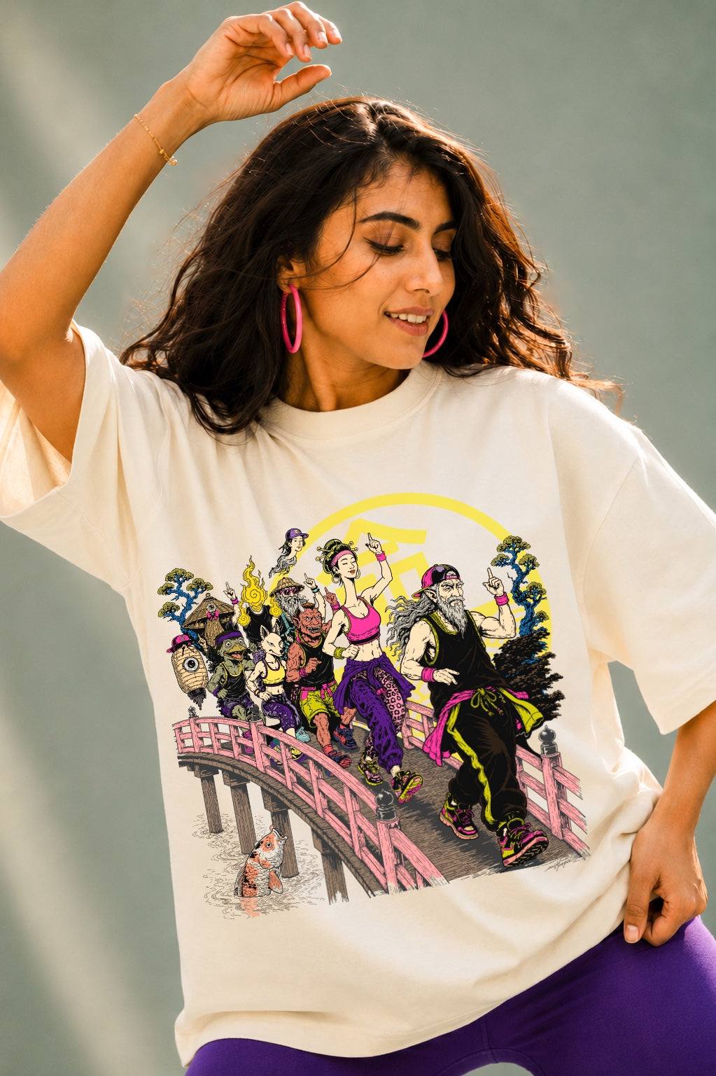 Woman wearing Mild Popie's March of Yokai premium oversized graphic T-shirt featuring original Japanese Yokai-inspired artwork during a Zumba dance session.