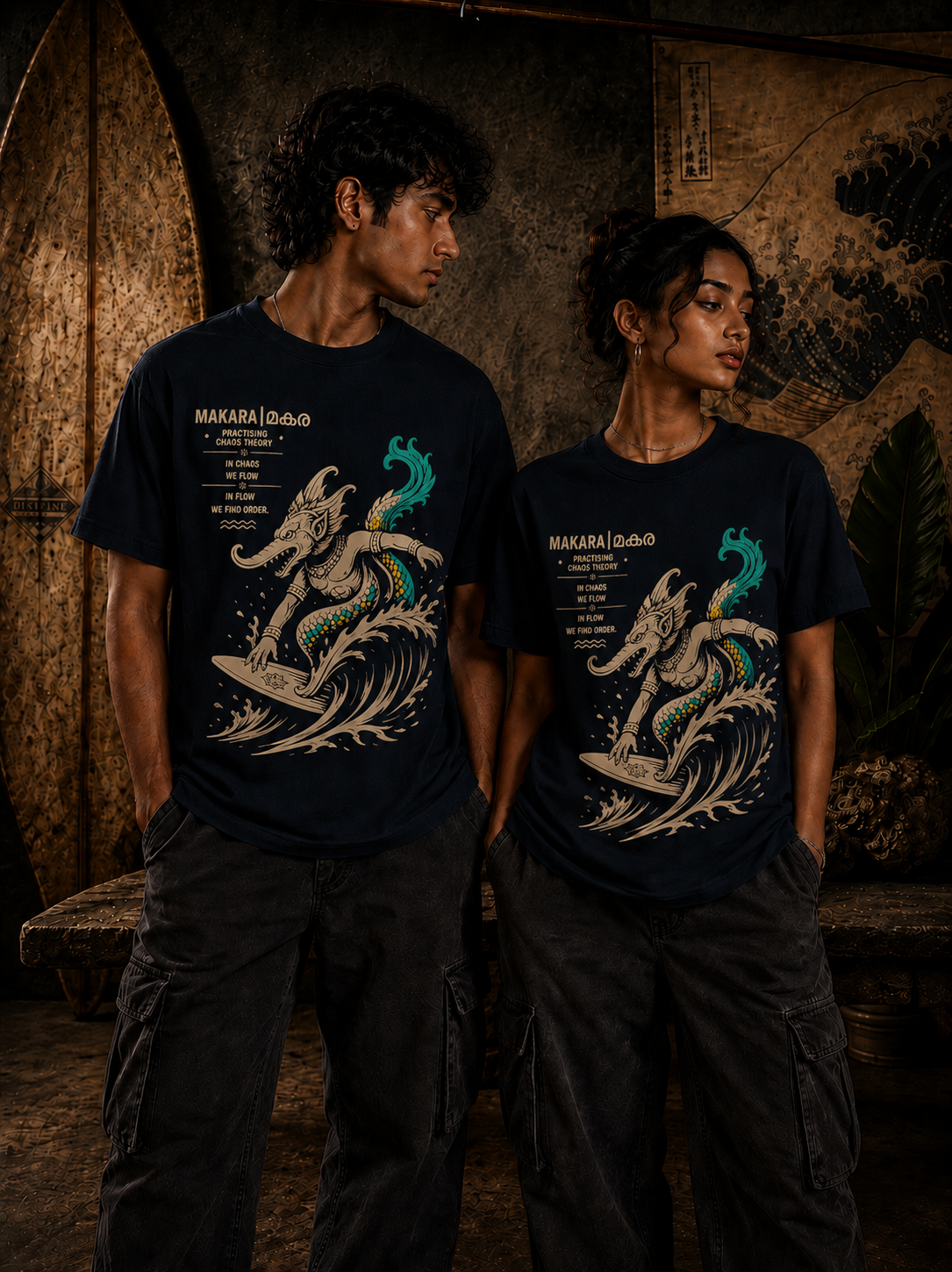 Male and female models wearing Surfing Makara regular fit t-shirt in black with surfing mythological artwork – Mild Popie