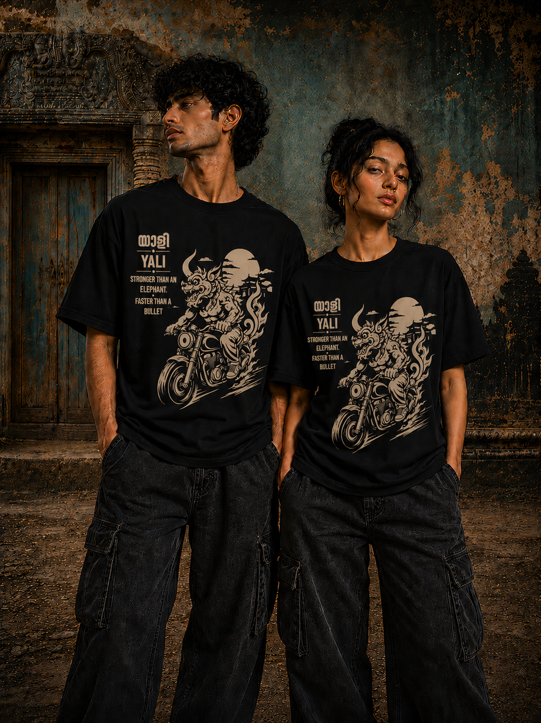 Male and female models wearing Yali Moto Rider regular fit t-shirt in black with motorcycle-inspired mythology artwork – Mild Popie