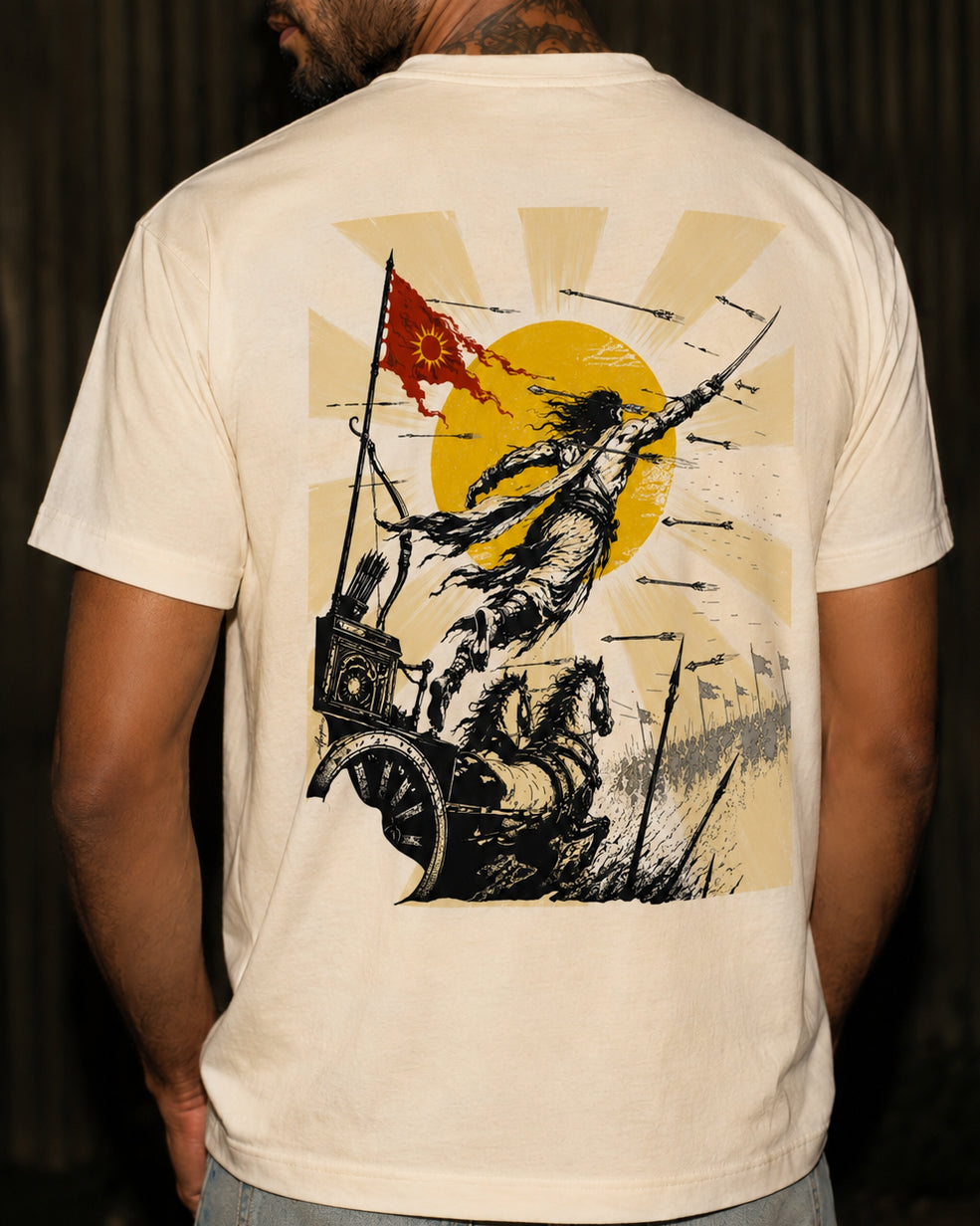 Lifestyle back view of a model wearing an off-white Karna graphic T-shirt featuring a Mahabharata-inspired warrior, chariot, horses and rising sun artwork.