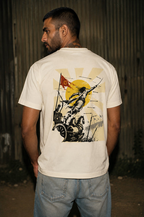 Model wearing an off-white graphic T-shirt featuring Karna leaping from a chariot with a rising sun inspired by the Mahabharata.